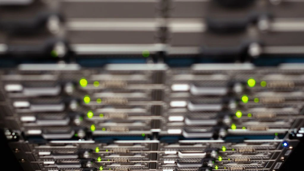 Rows of GPU server racks in a darkened AI data center